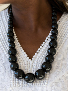 Gradually increasing in size near the center, refreshing black wooden beads are threaded along a black string for a summery look. Features an adjustable sliding knot closure.  Sold as one individual necklace. Includes one pair of matching earrings.