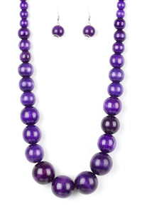 Gradually increasing in size near the center, vivacious purple wooden beads are threaded along a purple string for a summery look. Features an adjustable sliding knot closure.  Sold as one individual necklace. Includes one pair of matching earrings.