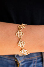 Load image into Gallery viewer, Ribbons of dotted gold twist into knotted metallic frames, creating an elegant look around the wrist. Features an adjustable clasp closure.  Sold as one individual bracelet.   Always nickel and lead free.