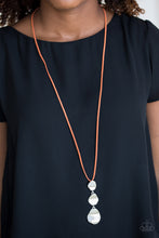 Load image into Gallery viewer, Delicately hammered in a glistening shimmer, asymmetrical silver frames link at the bottom of a lengthened orange suede strand for a bold artisanal look. Features an adjustable clasp closure.  Sold as one individual necklace. Includes one pair of matching earrings.  Always nickel and lead free.