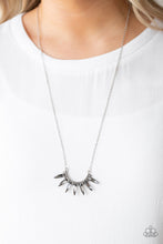 Load image into Gallery viewer, Smoky gems flare out from the bottom of a bowing silver frame encrusted in glittery hematite rhinestones. The ornate pendant swings from the bottom of a mid-length silver chain for an edgy-glamorous look. Features an adjustable clasp closure.  Sold as one individual necklace. Includes one pair of matching earrings.  Always nickel and lead free. 