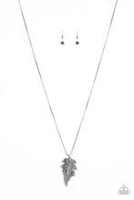 Load image into Gallery viewer, Encrusted in smoky rhinestones and stacked with linear textures, feathery silver leaf pendants swing from the bottom of a lengthened silver chain for a seasonal flair. Features an adjustable clasp closure.  Sold as one individual necklace. Includes one pair of matching earrings.