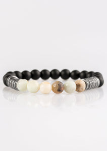 Infused with antiqued metallic accents, smooth black and energetic natural stone beads are threaded along a stretchy elastic band for a seasonal look.