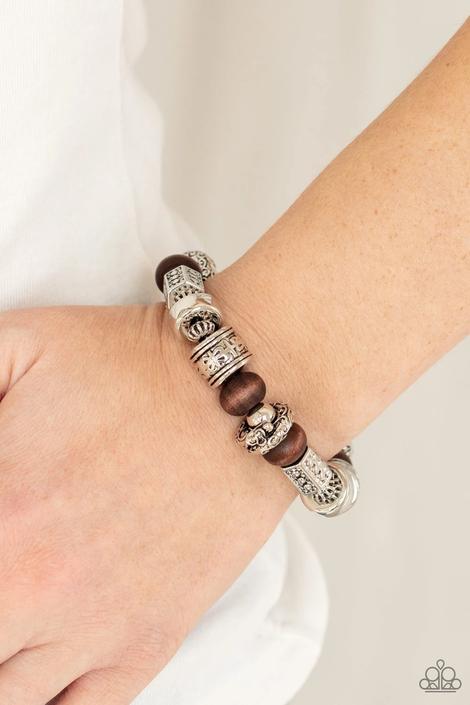Stamped, studded, and embossed in tribal inspired patterns, a collection of chunky silver beads join earthy wooden beads along a stretchy band around the wrist for an earthy flair.  Sold as one individual bracelet.  Always nickel and lead free.  Fashion Fix Exclusive June 2021