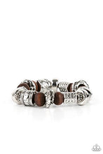 Load image into Gallery viewer, Stamped, studded, and embossed in tribal inspired patterns, a collection of chunky silver beads join earthy wooden beads along a stretchy band around the wrist for an earthy flair.  Sold as one individual bracelet.  Always nickel and lead free.  Fashion Fix Exclusive June 2021