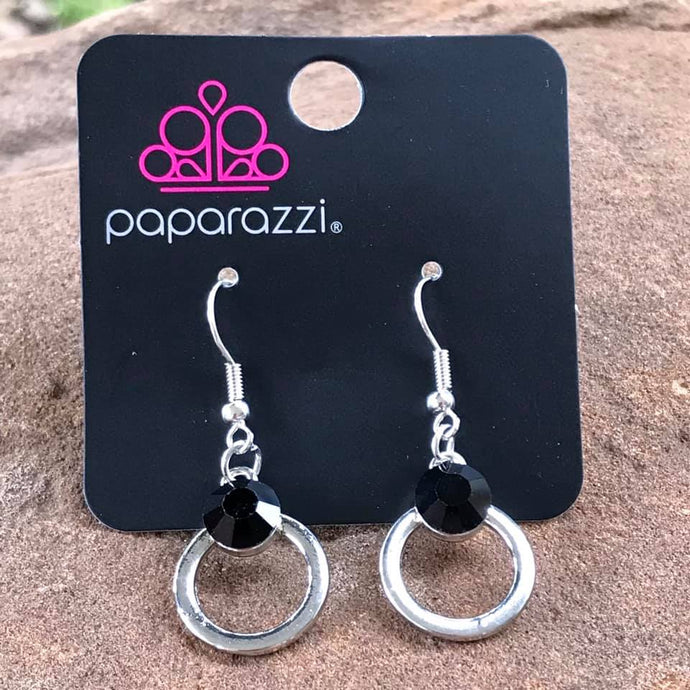 An over-sized black rhinestone crowns the top of a glistening silver hoop for a refined look. Earring attaches to a standard fishhook fitting.  Sold as one pair of earrings.  Always nickel and lead free.
