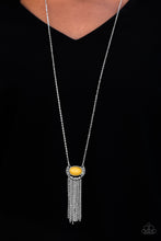 Load image into Gallery viewer, An earthy yellow bead is pressed into the center of a rustic silver frame. Varying in shape and shimmer, glistening silver chains stream from the bottom of the whimsical pendant for a seasonal finish. Features an adjustable clasp closure.  Sold as one individual necklace. Includes one pair of matching earrings.  Always nickel and lead free.