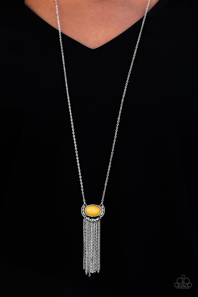 An earthy yellow bead is pressed into the center of a rustic silver frame. Varying in shape and shimmer, glistening silver chains stream from the bottom of the whimsical pendant for a seasonal finish. Features an adjustable clasp closure.  Sold as one individual necklace. Includes one pair of matching earrings.  Always nickel and lead free.
