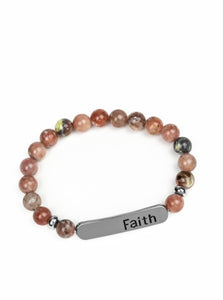 A collection of multicolored stones, dainty silver beads, and a silver plate stamped with the inspirational word, "faith", are threaded along a stretchy band around the wrist for a seasonal look.  Sold as one individual bracelet.