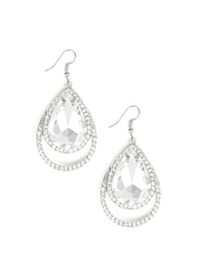 A dramatically over sized white teardrop gem is pressed into a doubled silver frame encrusted in countless white rhinestones for a blinding look. Earring attaches to a standard fishhook fitting.  Sold as one pair of earrings.