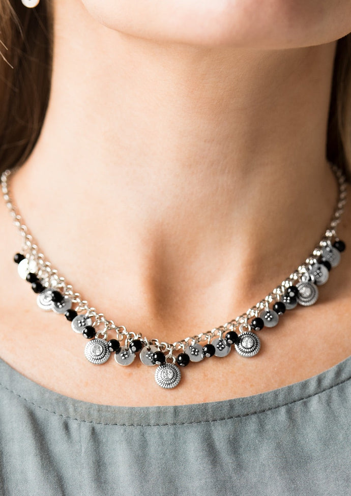 Dainty black beads and ornate silver discs swing from the bottom of a shimmery silver chain, creating a casual fringe below the collar. Featuring rhinestone centers, textured silver discs are sprinkled between refined beading for a glamorous finish. Features an adjustable clasp closure.  Sold as one individual necklace. Includes one pair of matching earrings.