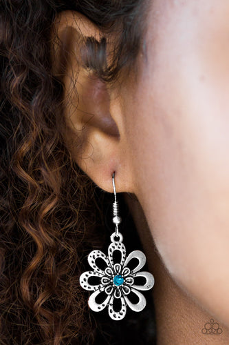 Smooth and hammered silver petals bloom from a radiant blue rhinestone center, creating a whimsical frame. Earring attaches to a standard fishhook fitting.  Sold as one pair of earrings.    Always nickel and lead free.