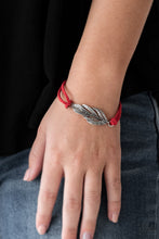 Load image into Gallery viewer, Strands of fiery red suede knot around a shimmery silver feather charm, creating a seasonal pendant atop the wrist. Features an adjustable clasp closure.  Sold as one individual bracelet.  Always nickel and lead free.