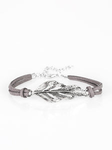Strands of gray suede knot around a shimmery silver feather charm, creating a seasonal pendant atop the wrist. Features an adjustable clasp closure.  Sold as one individual bracelet. 