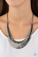 Load image into Gallery viewer, Etched in linear patterns, dramatic gunmetal plates connect below the collar, joining into a fierce crescent-shaped pendant for a statement making look. Features an adjustable clasp closure.  Sold as one individual necklace. Includes one pair of matching earrings.  Always nickel and lead free.