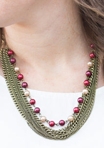 A strand of classic colorful pearls gives way to layers of mismatched brass chain, creating a fierce look below the collar. Features an adjustable clasp closure.  Sold as one individual necklace. Includes one pair of matching earrings.