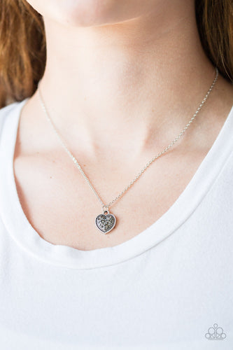 Encrusted in smoky rhinestones, a dainty silver heart pendant swings below the collar for a flirty look. Features an adjustable clasp closure.  Sold as one individual necklace. Includes one pair of matching earrings.  Always nickel and lead free.