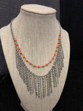 Load image into Gallery viewer, Dainty orange beads swing gently from a silver chain,  with a bold fringe below the collar for a fun look. Features an adjustable clasp closure.  Sold as one individual necklace. Includes one pair of matching earrings.  Always nickel and lead free.  Exclusive