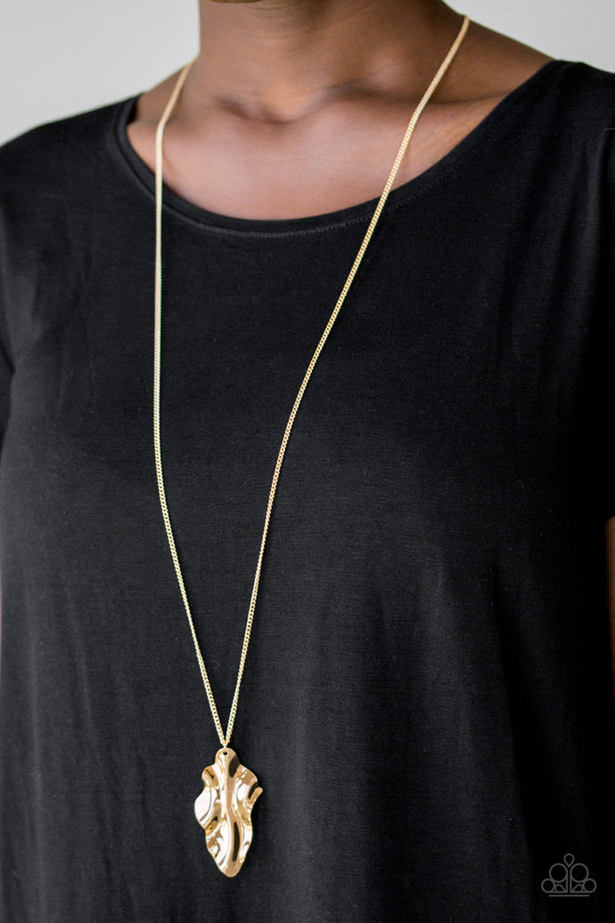 ﻿An elongated gold chain gives way to a rippling gold leaf-like pendant for a seasonal look. Features an adjustable clasp closure.  Sold as one individual necklace. Includes one pair of matching earrings.
