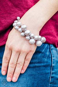 Varying in size, bubbly silver pearls cascade from the bottom of a bold silver chain, creating a dramatically clustered fringe around the wrist. Features an adjustable clasp closure.  Sold as one individual bracelet.