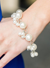 Load image into Gallery viewer, Infused with clusters of dainty white pearls, oversized pearls link around the wrist, creating a bubbly fringe. Features an adjustable clasp closure.  Sold as one individual bracelet.