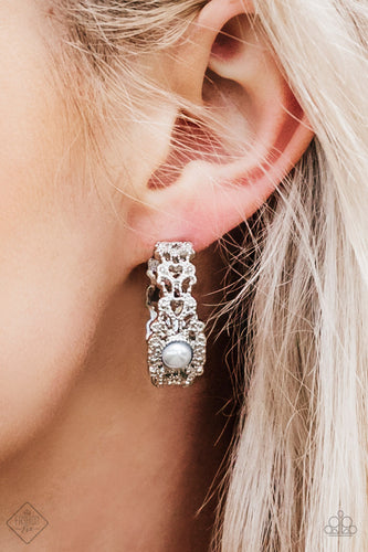 Dotted in shimmery silver textures, a frilly filigree hoop swings from the ear in a refined fashion. A pearly silver bead adorns the center of the hoop for a glamorous finish. Earring attaches to a standard post fitting. Hoop measures 1