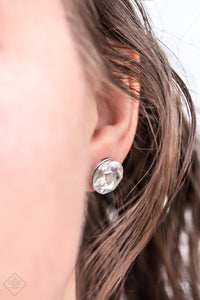 A sparkling white rhinestone is nestled inside a round silver frame for a timeless look. Earring attaches to a standard post fitting.  Sold as one pair of post earrings.   Fiercely 5th Avenue May 2018  Always nickel and lead free. 