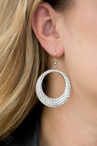 <p> </p> <p>A circular silver frame is encrusted in row after row of glassy white rhinestones. The bottom edge of the frame is slightly thicker than the top, giving way to an added blast of dramatically blinding shimmer. Earring attaches to a standard fishhook fitting.</p> <p><i>Sold as one pair of earrings.  </i></p>