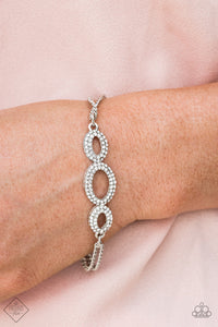 Encrusted in glassy white rhinestones, shiny silver ovals delicately connect across the front of the wrist for a timelessly sophisticated look. Features an adjustable clasp closure.