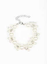 Load image into Gallery viewer, Infused with clusters of dainty white pearls, oversized pearls link around the wrist, creating a bubbly fringe. Features an adjustable clasp closure.  Sold as one individual bracelet.