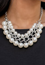 Load image into Gallery viewer, Two strands of dramatic white pearls collide with a strand of oversized silver chain. The layers fall along the collar to create a unique statement piece that boasts a mix of industrial grit and timeless refinement. Features an adjustable clasp closure.