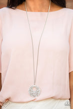 Load image into Gallery viewer,  A scatter of dainty white pearls and glassy white rhinestones coalesce into a dramatic circular pendant that swings at the bottom of a lengthened silver chain for a timeless look. Features an adjustable clasp closure.