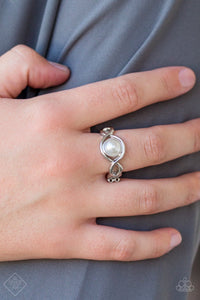 listening silver bars weave around a white pearl-drop center, creating a refined centerpiece atop the finger. Features a dainty stretchy band for a flexible fit.