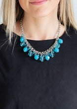 Load image into Gallery viewer, A collection of glassy and opaque blue crystal-like beads swing from the bottom of interlocking silver chains, creating a fabulous fringe below the collar. Features an adjustable clasp closure.  Sold as one individual necklace. Includes one pair of matching earrings.   