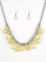 Load image into Gallery viewer, A collection of glassy and opaque yellow crystal-like beads swing from the bottom of interlocking silver chains, creating a fabulous fringe below the collar. Features an adjustable clasp closure.  Sold as one individual necklace. Includes one pair of matching earrings.