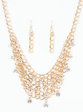 Load image into Gallery viewer, A collar of layered interlocking gold chain provides the canvas for gorgeous clear rhinestones to sway delicately. Features an adjustable clasp closure.  Sold as one individual necklace. includes one pair of marching earrings.
