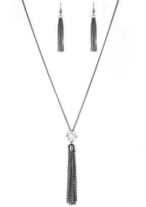 Infused with an elegantly elongated gunmetal chain, a dramatic white gem gives way to a shimmery gunmetal chain tassel for a glamorous look. Features an adjustable clasp closure.  Sold as one individual necklace. Includes one pair of matching earrings.  Always nickel and lead free.