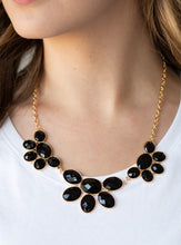 Load image into Gallery viewer, Gradually increasing in size near the center, a collection of black beaded gold frames link into a gorgeous statement piece. Featuring a faceted finish, the sparkling oval beaded frames fan out below the collar for a refined flair. Features an adjustable clasp closure.  Sold as one individual necklace. Includes one pair of matching earrings. 