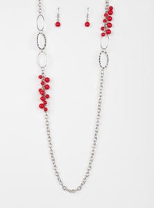 Smooth and hammered silver rings join clusters of fiery red beads along a shimmery silver chain for a colorful look. Features an adjustable clasp closure.  Sold as one individual necklace. Includes one pair of matching earrings.  