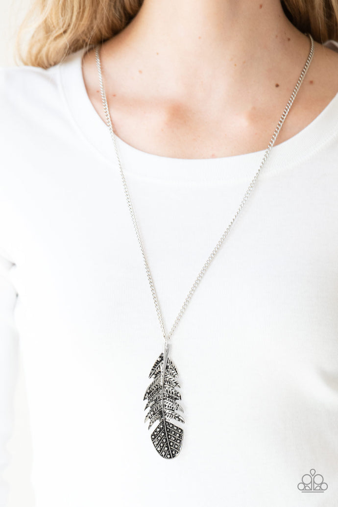 Featuring studded and antiqued textures, a dramatic silver feather pendant swings from the bottom of an elongated silver chain for a free-spirited fashion. Features an adjustable clasp closure.  Sold as one individual necklace. Includes one pair of matching earrings.  Always nickel and lead free.