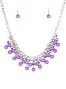 Rows of classic silver and vivacious purple beads trickle from two rows of interlocking silver chains, creating a bold colorful fringe below the collar. Features and adjustable clasp closure.  Sold as one individual necklace. Includes one pair of matching earrings.   