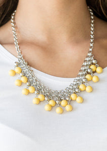 Rows of classic silver and sunny yellow beads trickle from two rows of interlocking silver chains, creating a bold colorful fringe below the collar. Features and adjustable clasp closure.  Sold as one individual necklace. Includes one pair of matching earrings.  