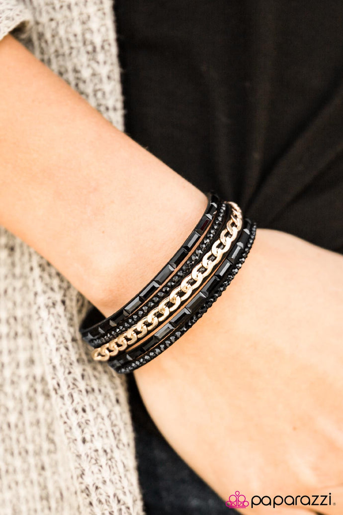 Dazzling black rhinestones, gold chain, and glassy emerald-cut beading embellishes a black suede band that has been spliced into undeniable rows of sparkle. Features an adjustable snap closure.  Sold as one individual bracelet.  Always nickel and lead free.