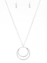 Load image into Gallery viewer, A daring circular pendant swings from the bottom of an elongated silver chain for a refined look. The bottoms of the ornate silver pendant are encrusted in white rhinestones for a glamorous finish. Features an adjustable clasp closure.  Sold as one individual necklace. Includes one pair of matching earrings.