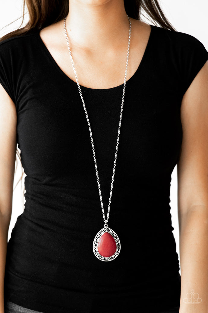 A red stone teardrop is pressed into the center of an ornate silver frame, creating a dramatic pendant for a seasonal look. Features an adjustable clasp closure.  Sold as one individual necklace. Includes one pair of matching earrings.  Always nickel and lead free.