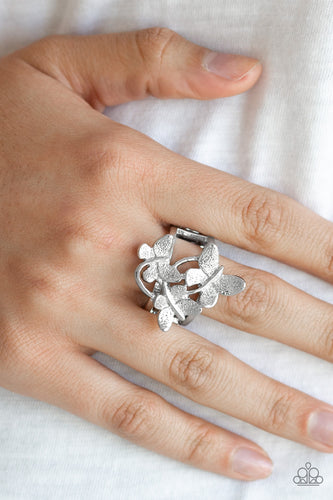 A trio of fluttering silver butterflies rest atop the finger, coalescing into a whimsical centerpiece. Features a stretchy band for a flexible fit.  Sold as one individual ring.  Always nickel and lead free.