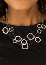 Load image into Gallery viewer, Delicately hammered in shimmer, round and square shiny silver frames are secured in place along three glistening wires. The floating frames drape below the collar in a refined fashion. Features an adjustable clasp closure.  Sold as one individual necklace. Includes one pair of matching earrings. 