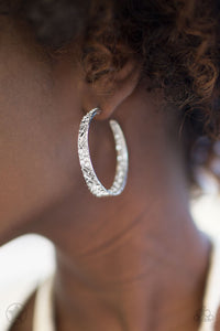 The front facing surface of a chunky silver hoop is dipped in brilliantly sparkling rhinestones while light-catching texture wraps around the back. The interior of the hoop features the opposite pattern, creating the illusion of a full hoop of blinding rhinestones. Earring attaches to a standard post fitting. Hoop measures 1 3/4" in diameter.  Sold as one pair of earrings.   Blockbuster!!