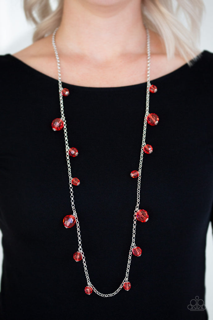 Varying in size, a collection of glassy red crystal-like beads trickle down a shimmery silver chain across the chest for a whimsical look. Features an adjustable clasp closure.  Sold as one individual necklace. Includes one pair of matching earrings.  Always nickel and lead free!