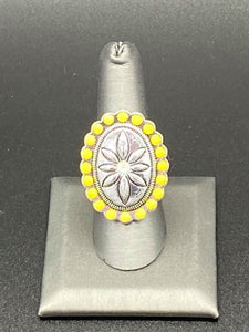 Raised flower with a iridescent white gem encased in the center of the flower   surrounded by yellow beads. Features a stretchy band for a flexible fit.  Sold as one individual ring.  Always nickel and lead free.